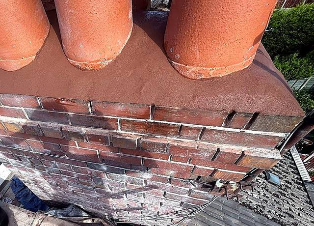 Chimney stack repointed with fresh mortar flaunching around four pots in Halesowen