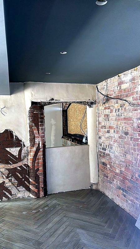 Commercial interior with exposed brick, plaster and herringbone floor in the West Midlands