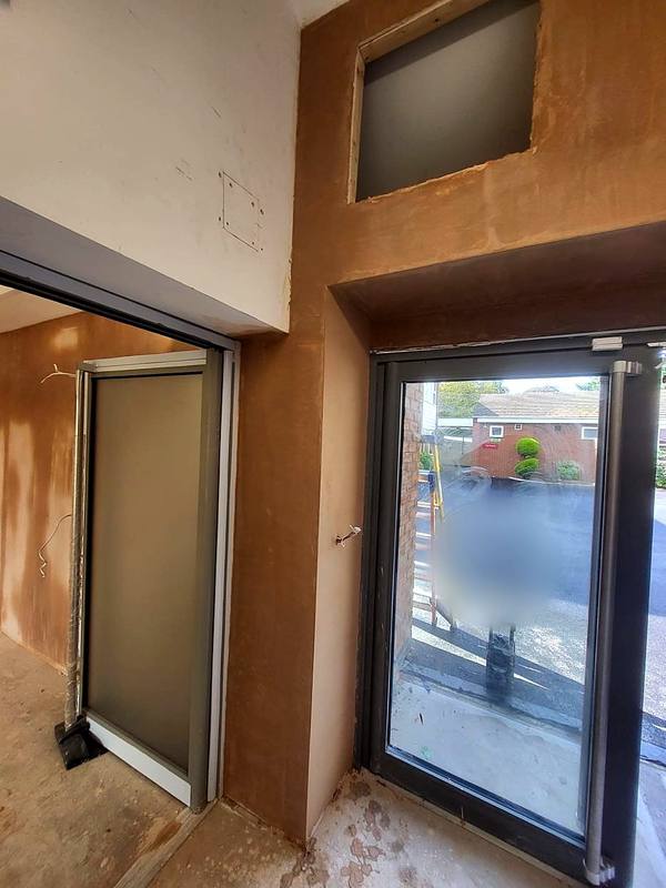 Walls around the entrance doors freshly plastered in the West Midlands