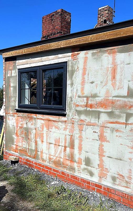 Basecoat and reinforcing mesh applied over insulation boards in the West Midlands