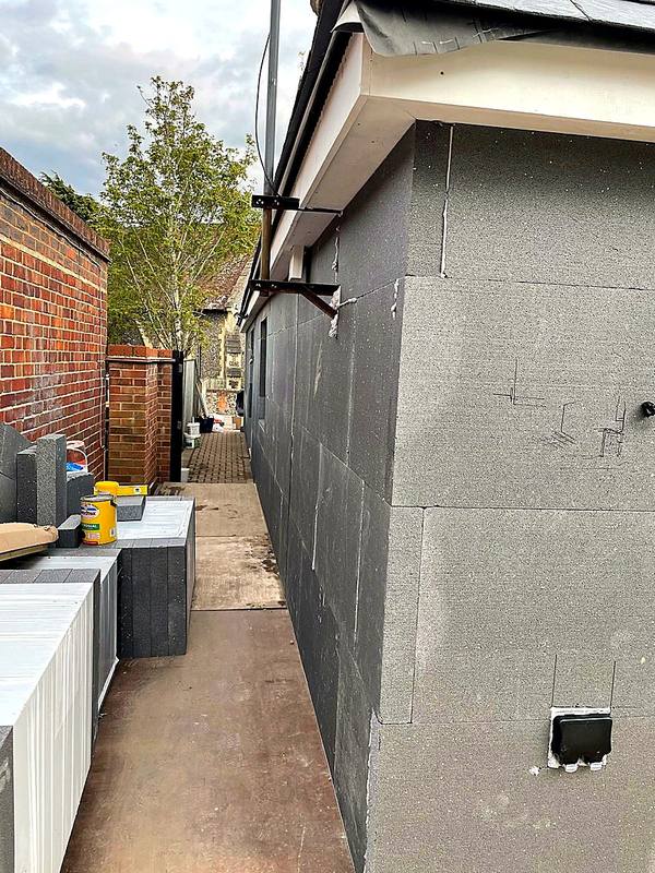 Grey insulation boards fixed to the side of a bungalow in the West Midlands