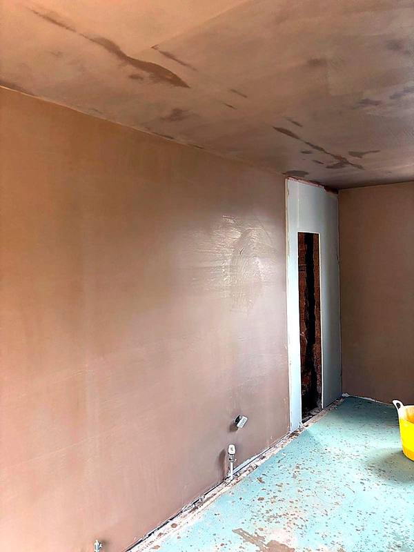 Freshly plastered walls and ceiling in an empty room in the West Midlands