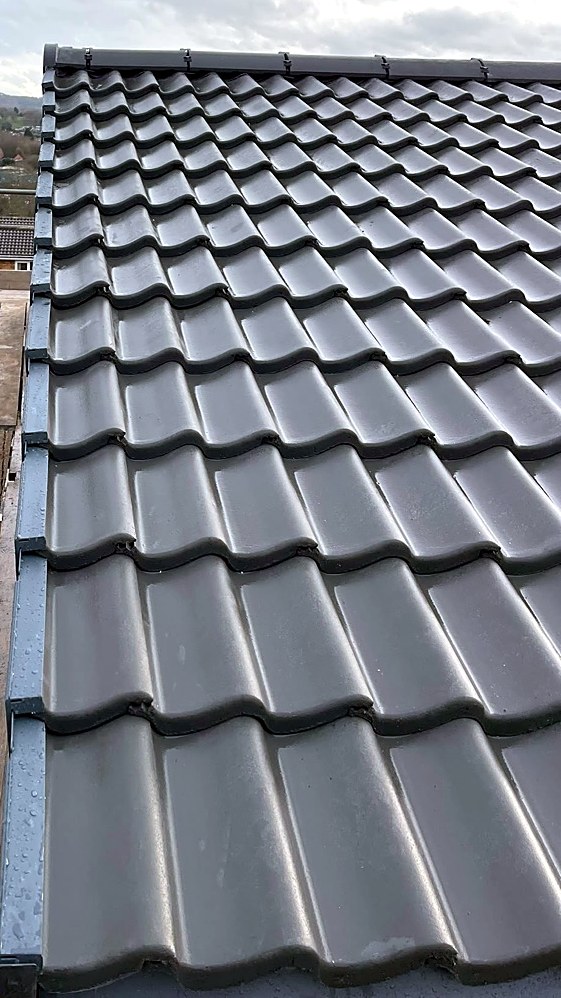 Close view of new interlocking tiles finished with a dry verge