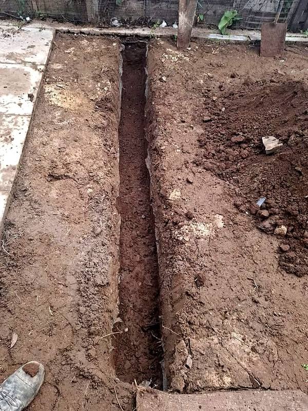 Trench dug in red soil for a new channel drain in Northfield