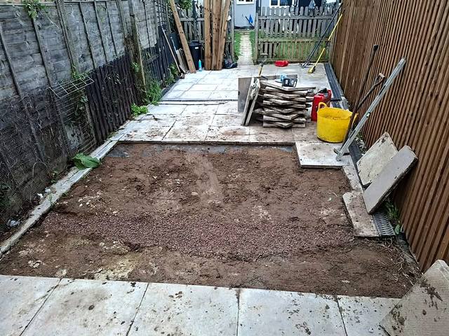 Fresh levelled bed prepared before relaying patio slabs in Northfield