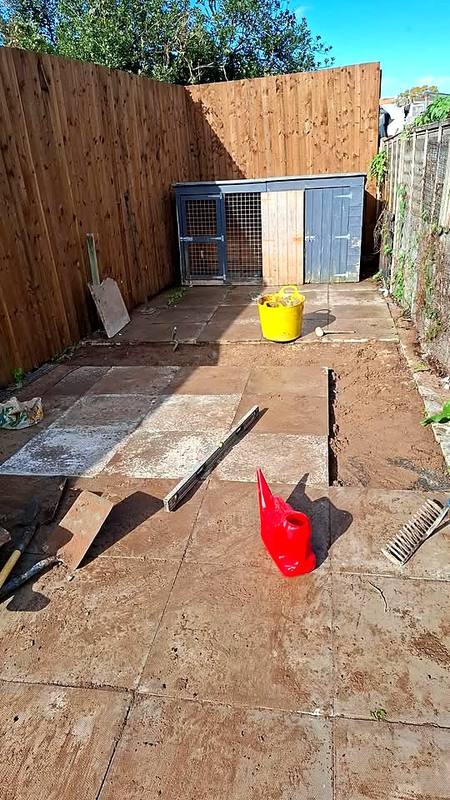 Spirit level on relaid patio slabs in Northfield