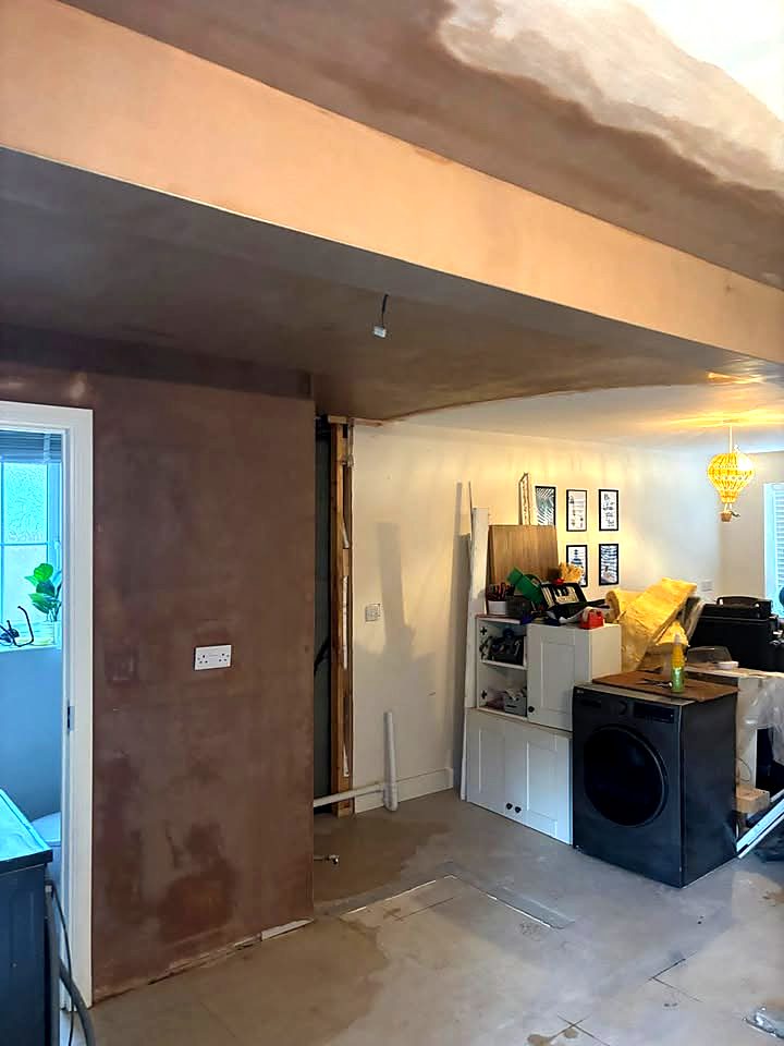 Freshly plastered boxed-in steel beam and ceiling after a kitchen knock-through in Stafford